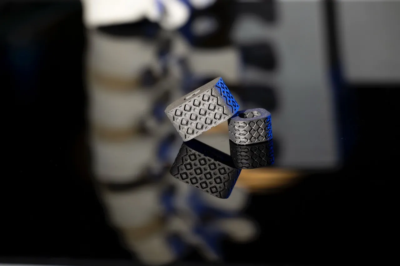 Metamaterial fusion cages in front of a model spine under blue light